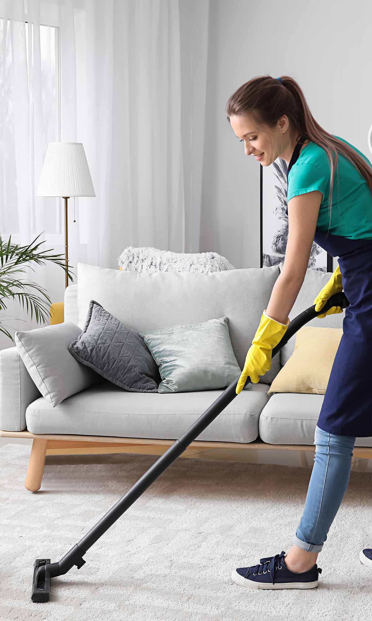 image of maid vacuuming carpet